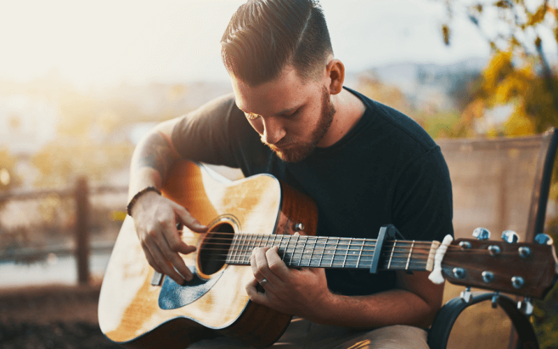 Image of a person practising playing a guitar.