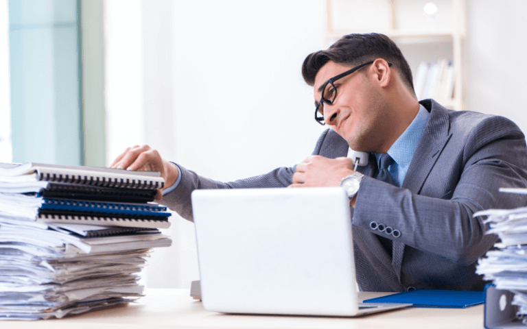 Stay Active and Inspired: Hobbies for Every Lifestyle in Singapore Image of a person sitting in front of a cluttered table of papers, and notebooks.