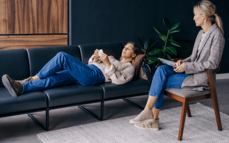 7 Reasons Why You Should Consider Regular Therapy Sessions Image of a person lying down on a couch talking to their therapist
