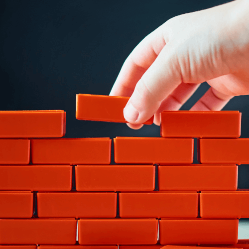 Small image of a person building a wall