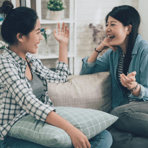 Small image of a person happily talking with a friend