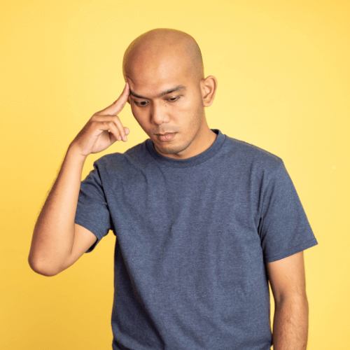 Small image of a person poking their forehead with a thinking expression