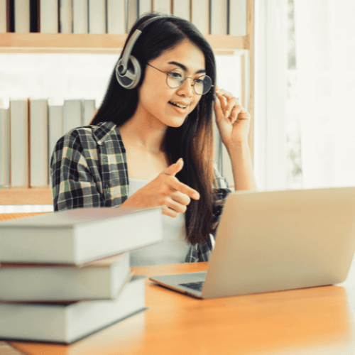 Small image of a person studying and doing assignments