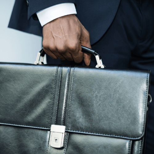 Small image of a person’s legs walking away while holding a briefcase